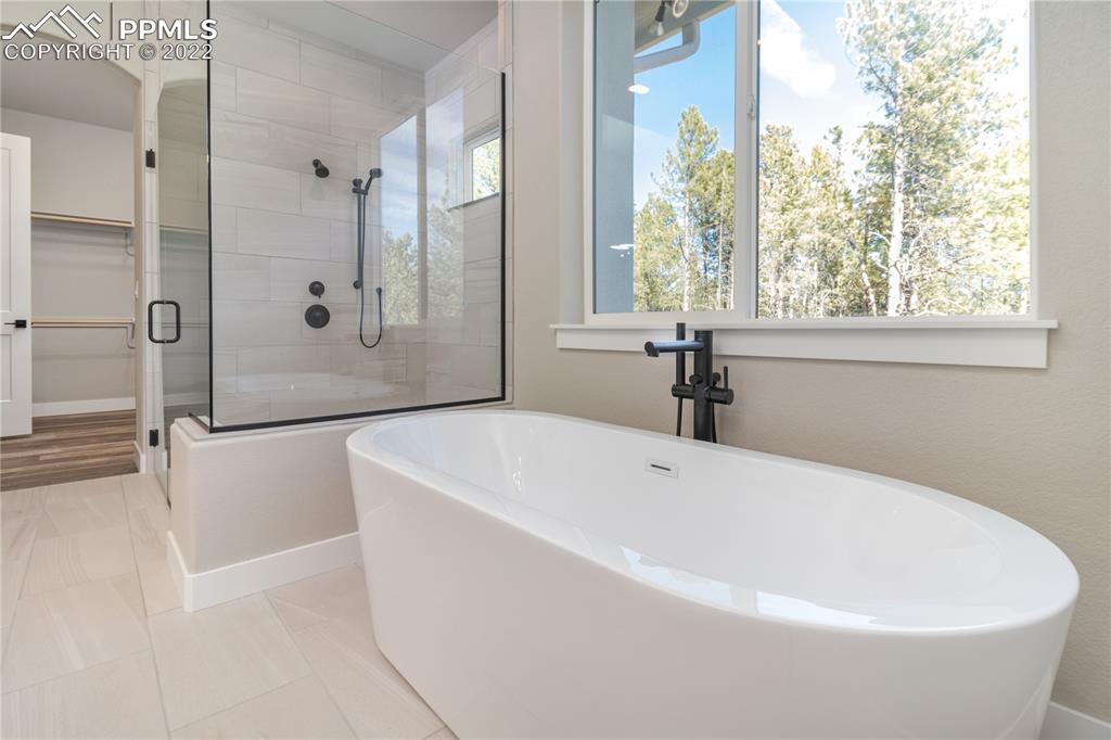 10675 Hardy Road Colorado Springs, CO 80908 - Photo 17 of 45 a white bath tub sitting in a bathroom next to a window
