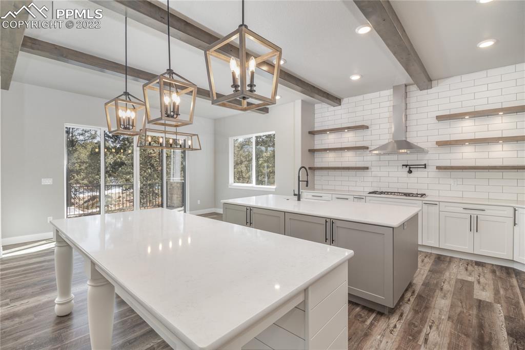 10675 Hardy Road Colorado Springs, CO 80908 - Photo 10 of 45 a large kitchen with kitchen island a large island in it