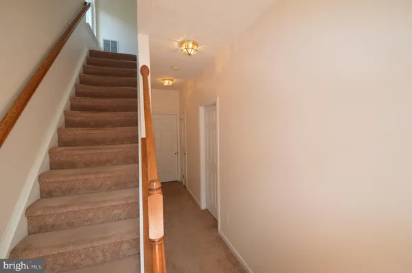 a view of staircase with white walls