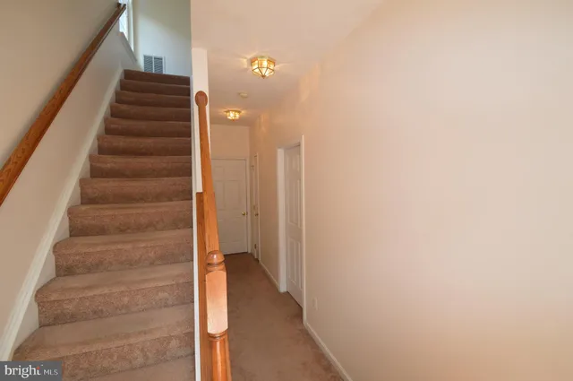 a view of staircase with white walls