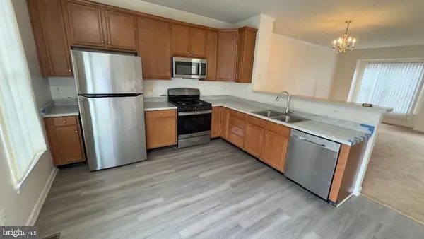 a kitchen with stainless steel appliances granite countertop a refrigerator stove and sink