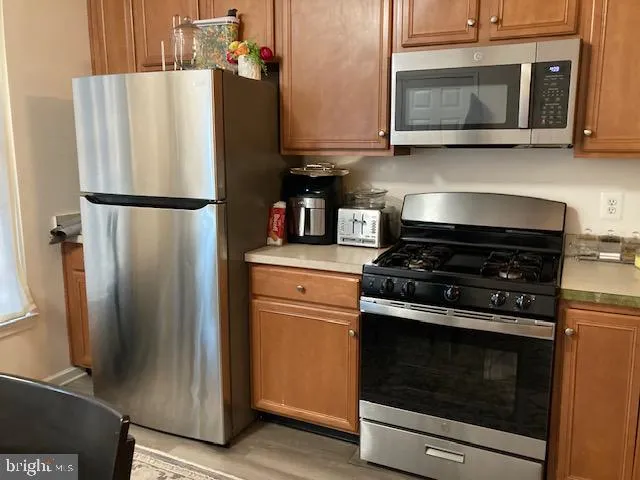 a kitchen with appliances and cabinets