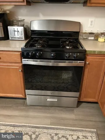 a stove top oven sitting inside of a kitchen