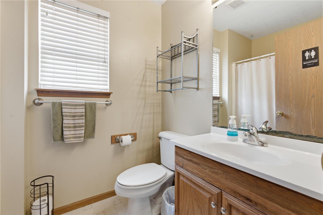8747 Waynes Way Blanchester, OH 45107 - Photo 15 of 40 This bathroom features a single vanity, a toilet, and a shower with a privacy curtain.