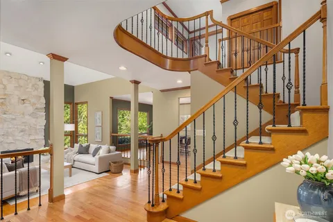 a view of entryway livingroom and hall with wooden floor