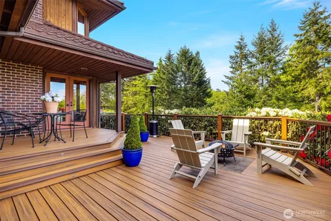 a view of a roof deck with couches and chairs