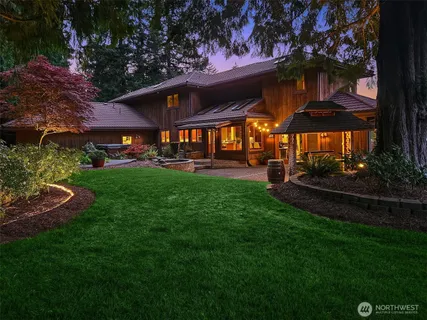 a view of a big room with a big yard potted plants and large tree
