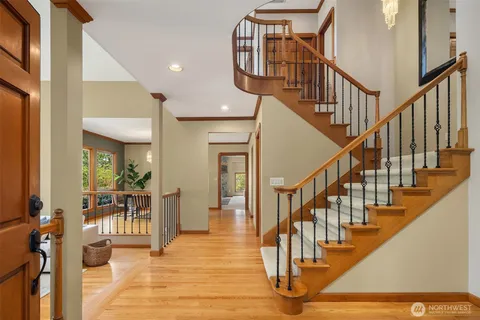 a view of entryway and hall with wooden floor