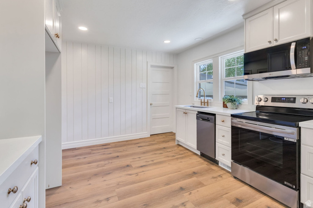 226 North 300 West Provo, UT 84601 - Photo 6 of 14 Kitchen featuring white cabinetry, light wood-finish flooring, recessed lighting, and stainless steel appliances including a range, microwave, and dishwasher