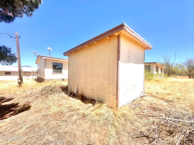 a big room with wooden fence and large trees