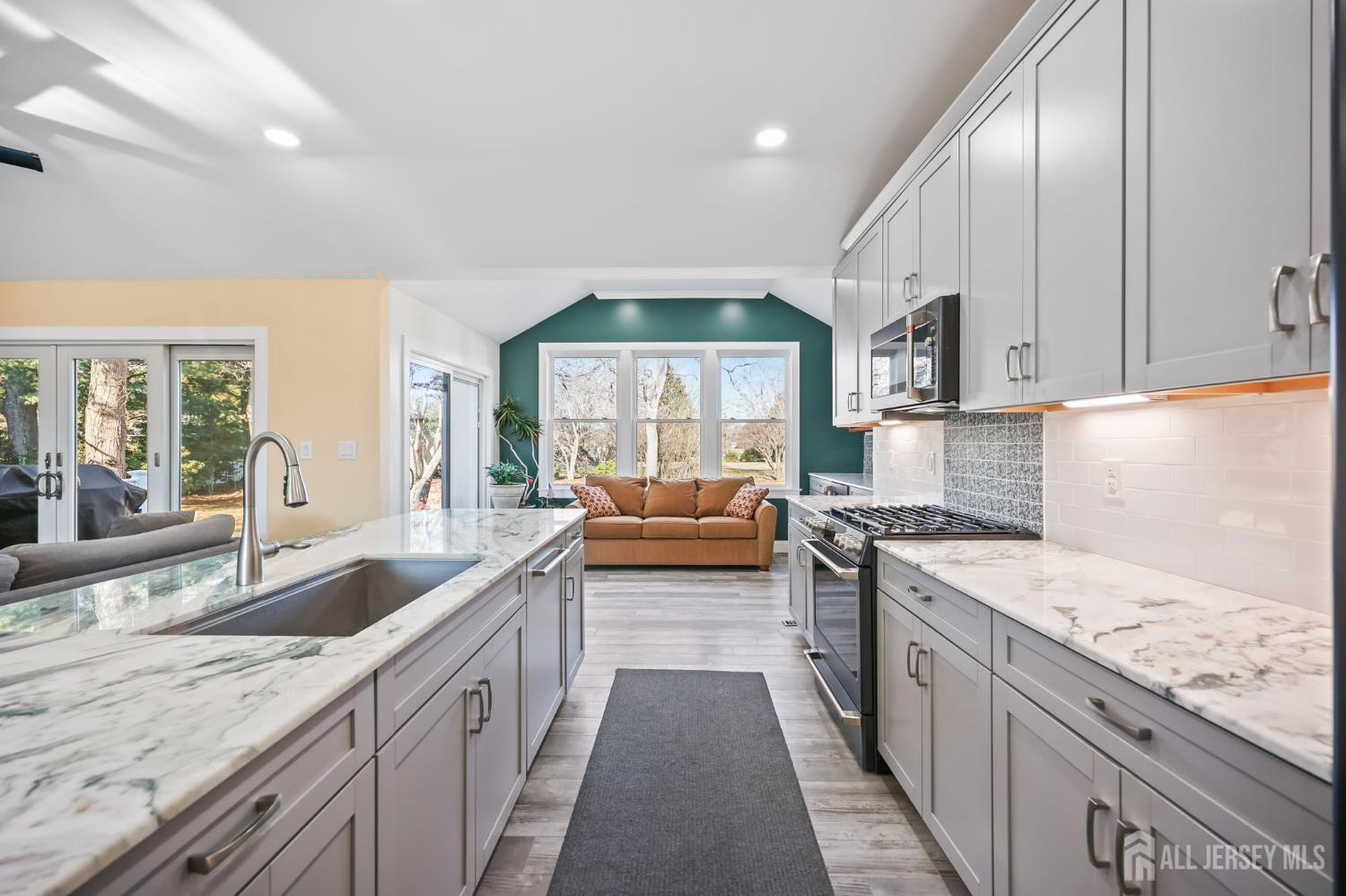 568 Village Road West Windsor, NJ 08550 - Photo 11 of 43 a kitchen with granite countertop stainless steel appliances a sink stove top oven and cabinets