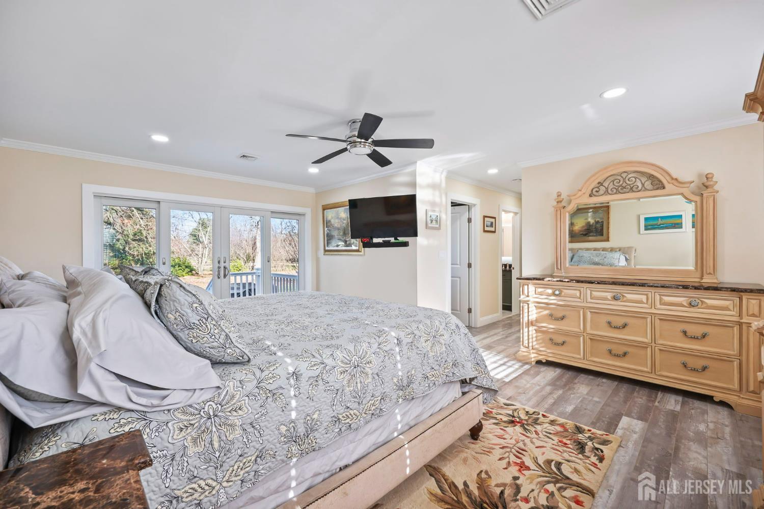 568 Village Road West Windsor, NJ 08550 - Photo 23 of 43 a spacious bedroom with a bed a ceiling fan and a dresser