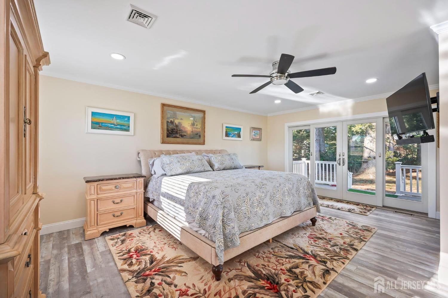 568 Village Road West Windsor, NJ 08550 - Photo 25 of 43 a living room with a bed and a flat screen tv