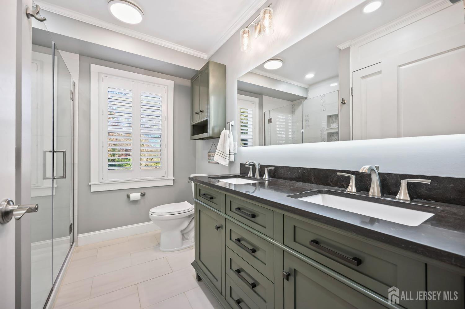 568 Village Road West Windsor, NJ 08550 - Photo 26 of 43 a bathroom with a granite countertop double vanity sink a mirror and a bathtub