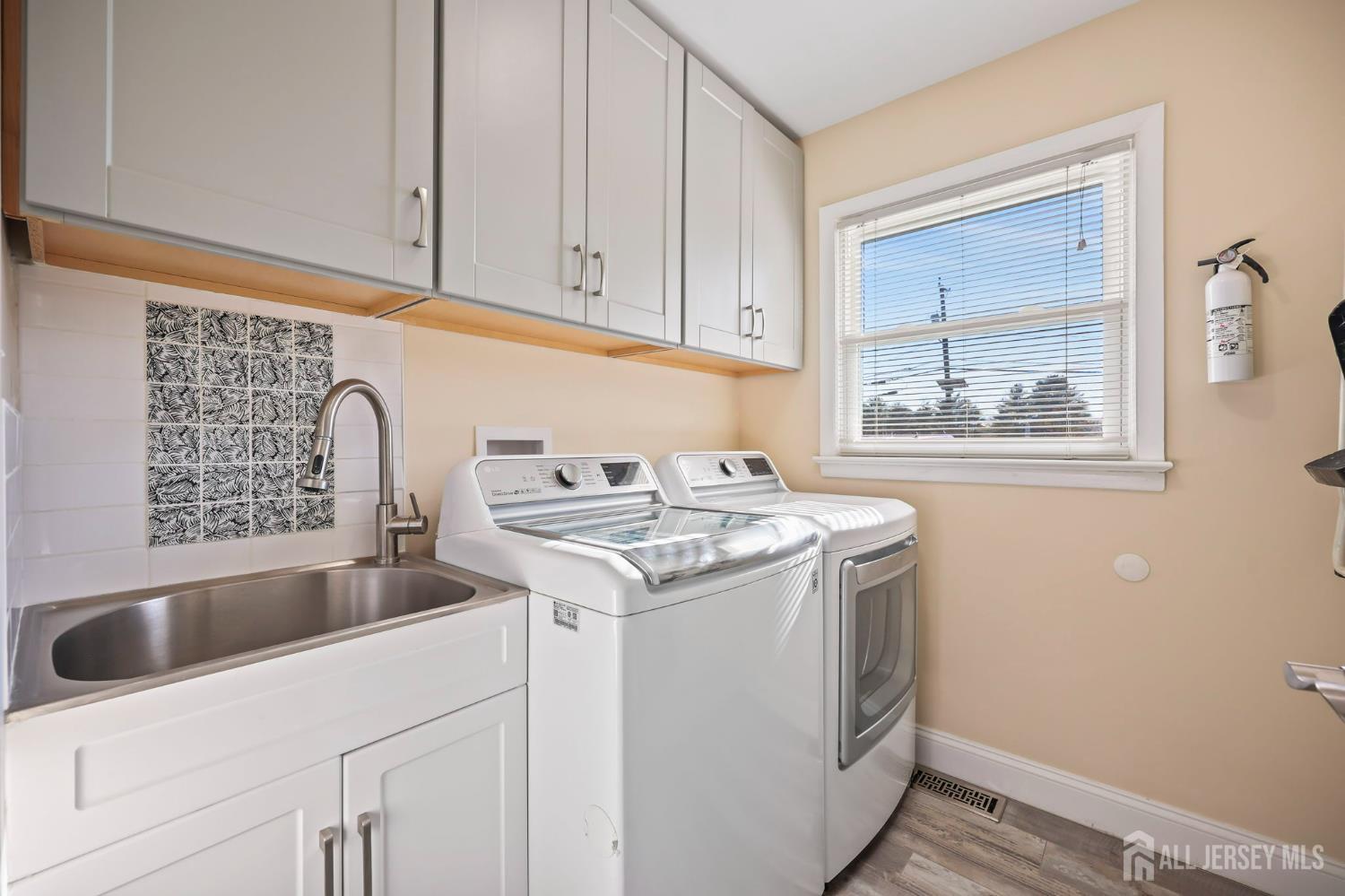 568 Village Road West Windsor, NJ 08550 - Photo 36 of 43 a utility room with sink dryer and washer
