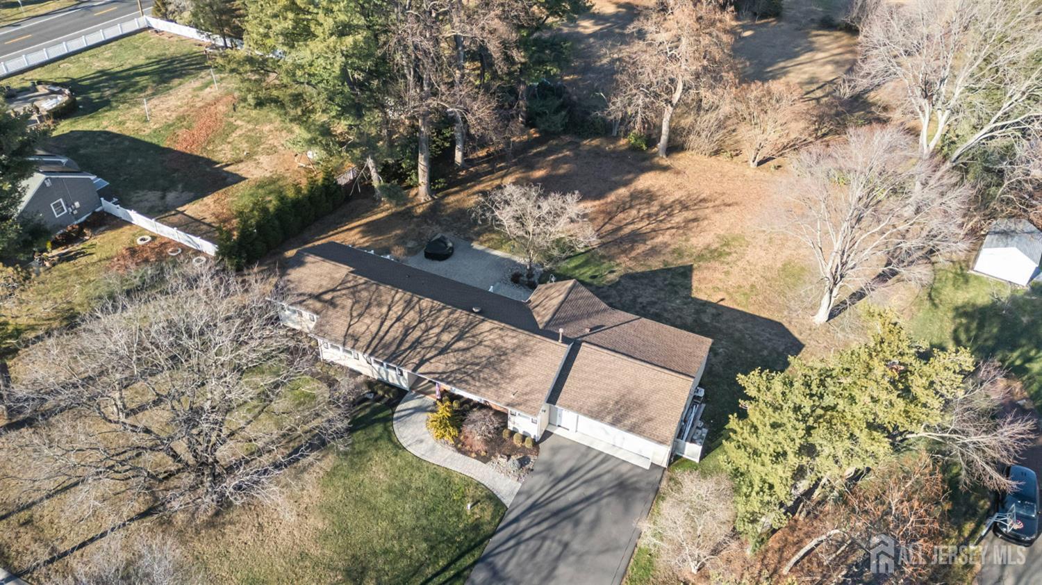 568 Village Road West Windsor, NJ 08550 - Photo 42 of 43 an aerial view of a house with a yard and large trees