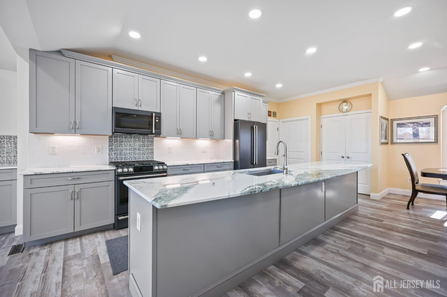 568 Village Road West Windsor, NJ 08550 - Photo 7 of 43 a kitchen with stainless steel appliances granite countertop a sink stove and refrigerator
