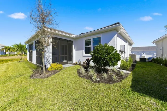a view of a house with backyard and sitting area