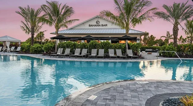 a view of a swimming pool with a table and chairs