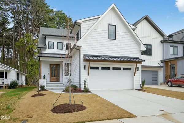 a front view of a house with a yard garage and outdoor seating