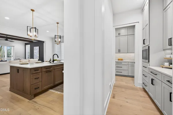 a kitchen with kitchen island granite countertop a sink counter top space and stainless steel appliances