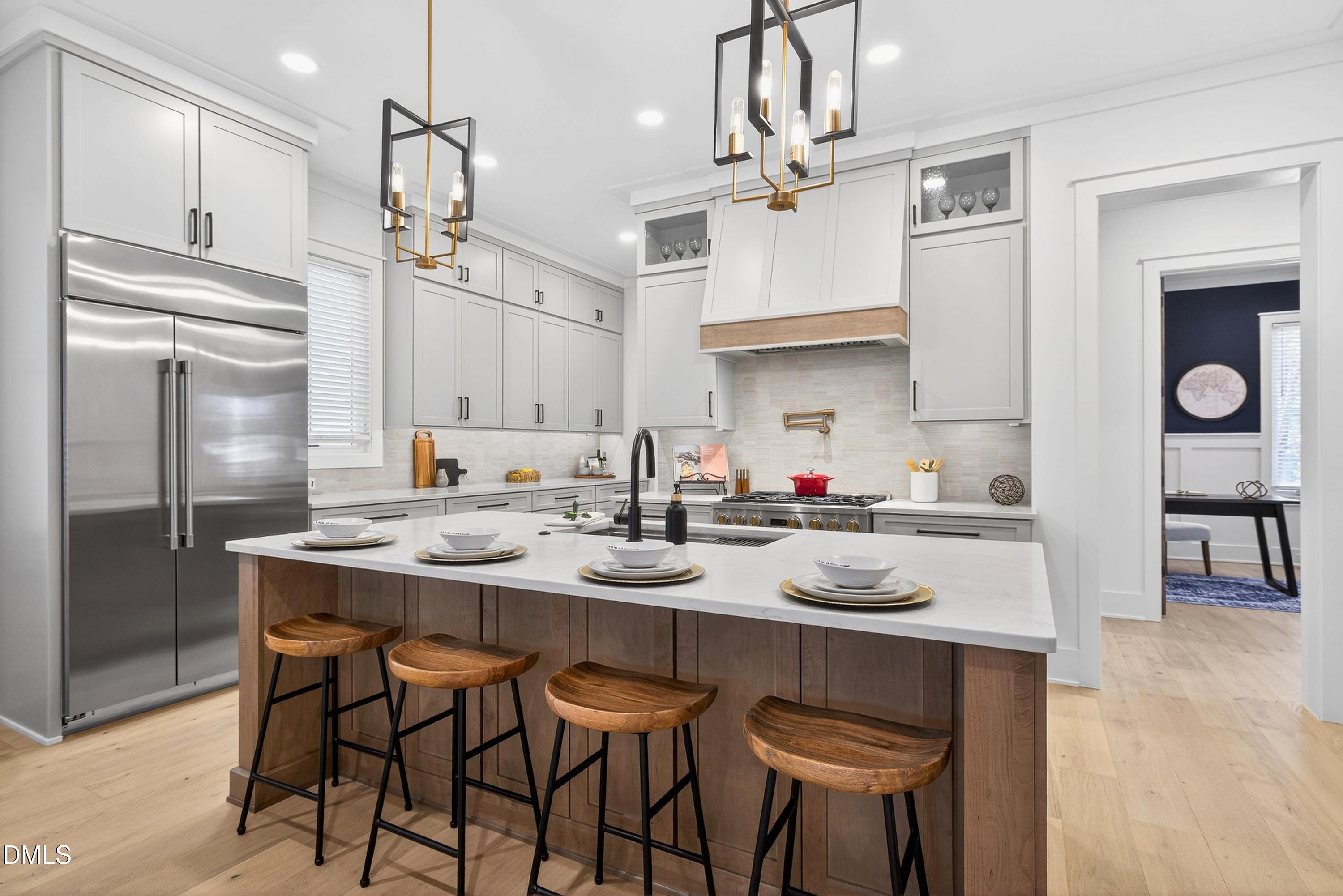 113 Boyd Street Cary, NC 27513 - Photo 18 of 88 a kitchen with stainless steel appliances kitchen island granite countertop a table chairs sink and cabinets