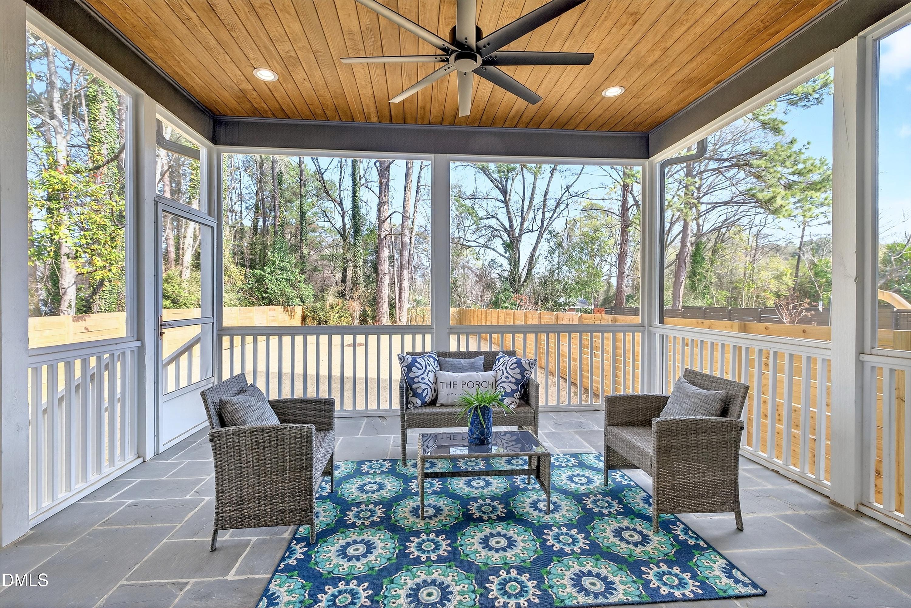 113 Boyd Street Cary, NC 27513 - Photo 32 of 88 a living room with furniture and a floor to ceiling window