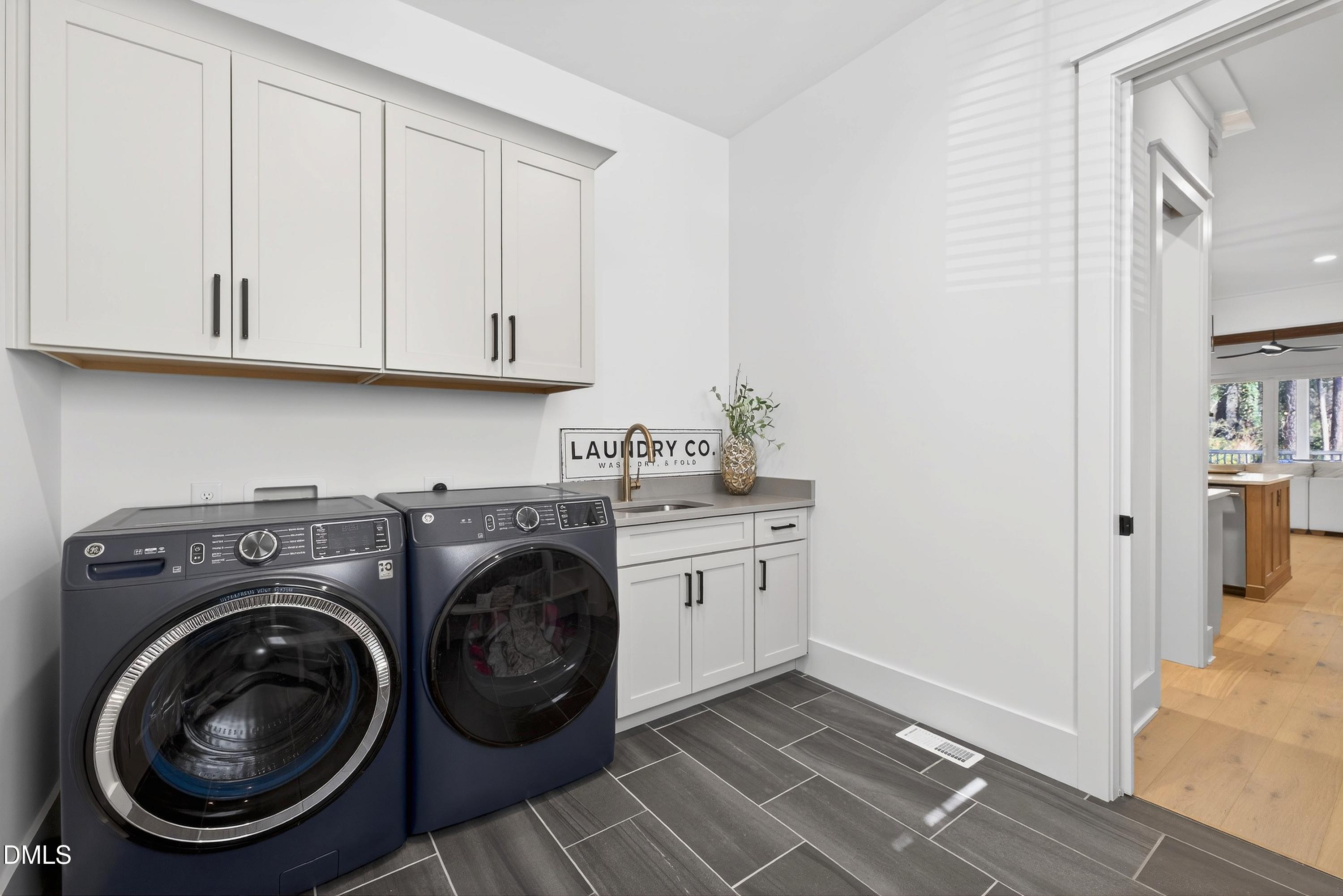 113 Boyd Street Cary, NC 27513 - Photo 35 of 88 a utility room with sink dryer and washer