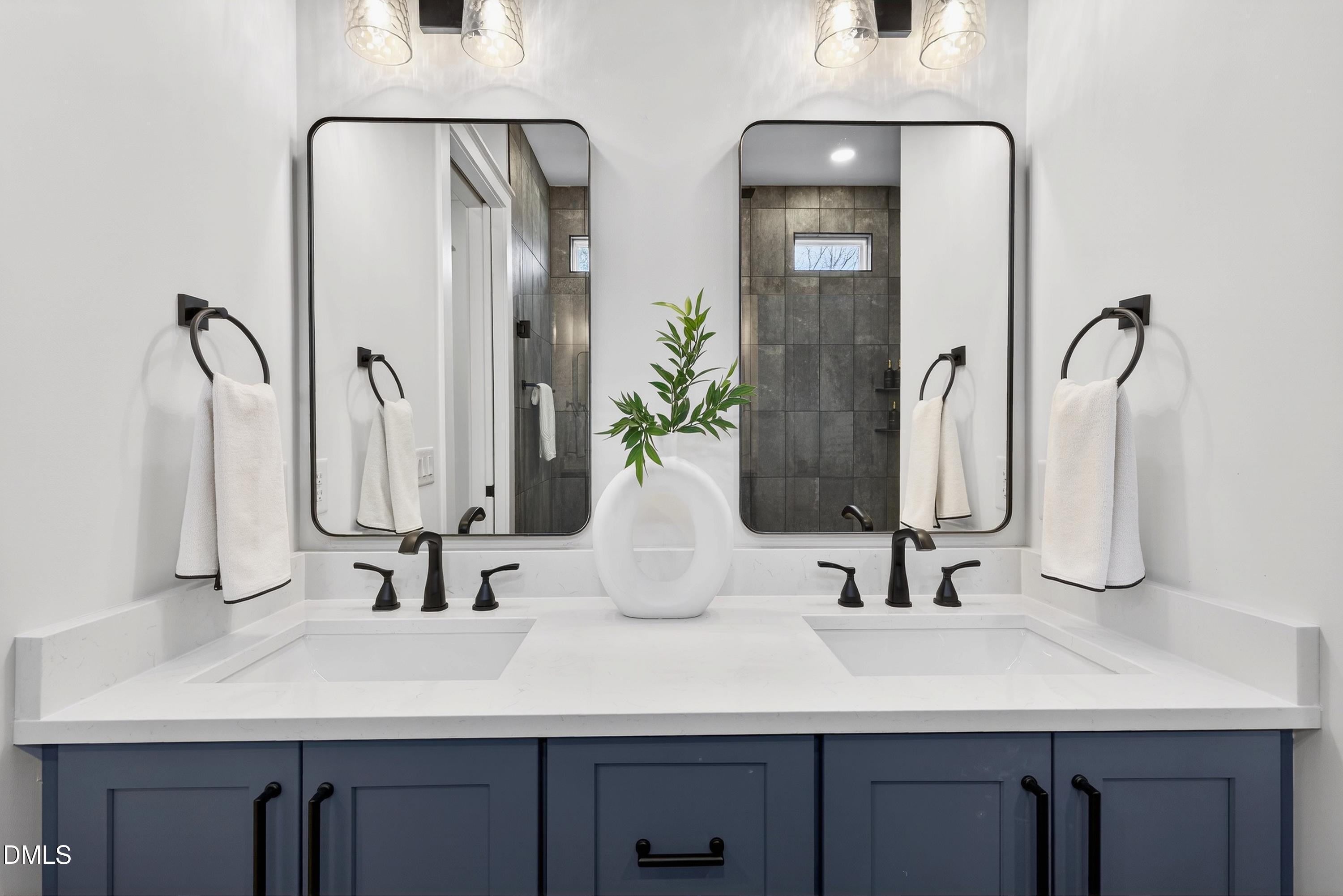 113 Boyd Street Cary, NC 27513 - Photo 39 of 88 a bathroom with double vanity sinks and a mirror