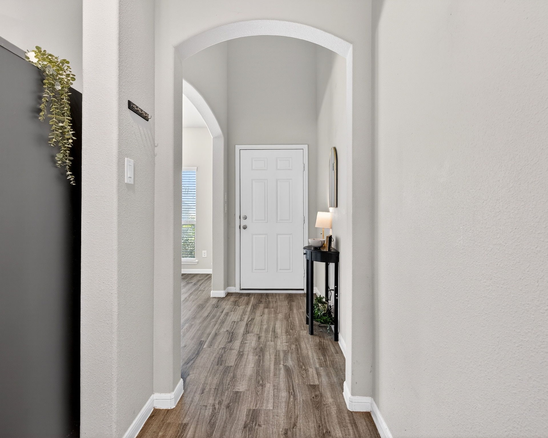 2121 Cedar Way Drive Conroe, TX 77301 - Photo 5 of 27 a view of a hallway with wooden floor and a bathroom
