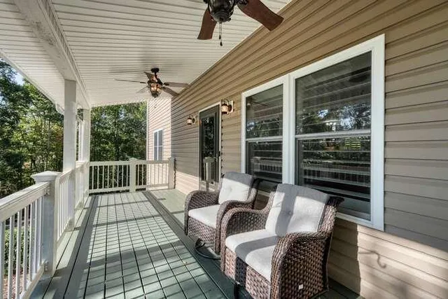 a kitchen with stainless steel appliances granite countertop a refrigerator a sink dishwasher a stove and white countertops with wooden floor