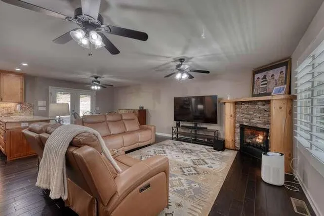 a kitchen that has a lot of cabinets and wooden floor