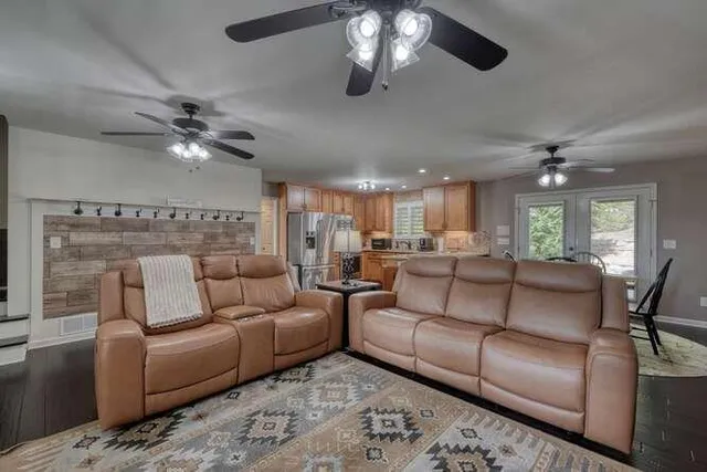 a kitchen that has a lot of cabinets in it and wooden floors