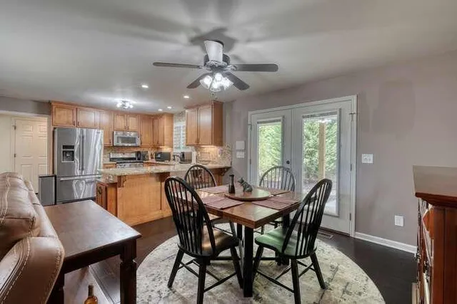 a kitchen with granite countertop a stove top oven and refrigerator