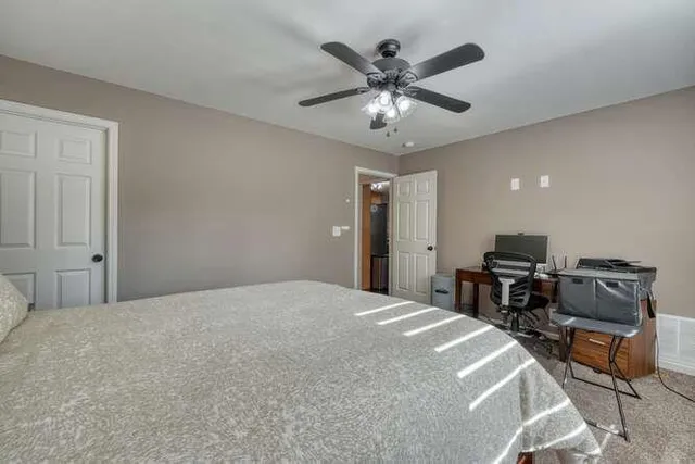 a living room with furniture and a ceiling fan
