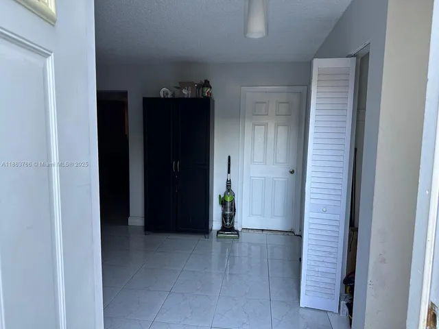 a view of a hallway with paintings on the wall