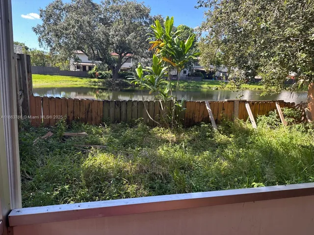 a kitchen with granite countertop a stove sink and cabinets