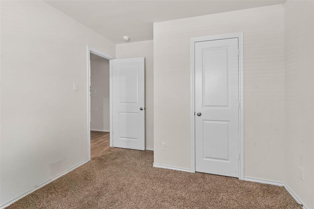 409 Wilson Way Denton, TX 76207 - Photo 19 of 33 Neutral tone painted walls complement the brown carpet flooring