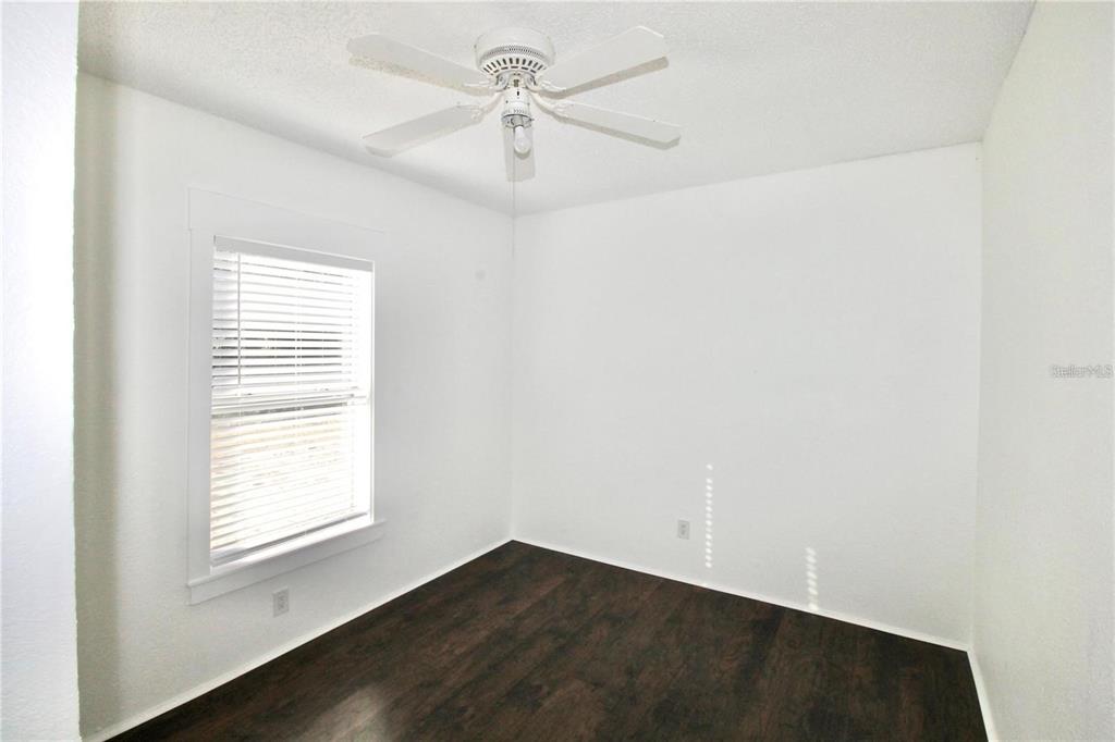 610 Dundee Road, Unit 1 Dundee, FL 33838 - Photo 13 of 28 an empty room with a window and a ceiling fan