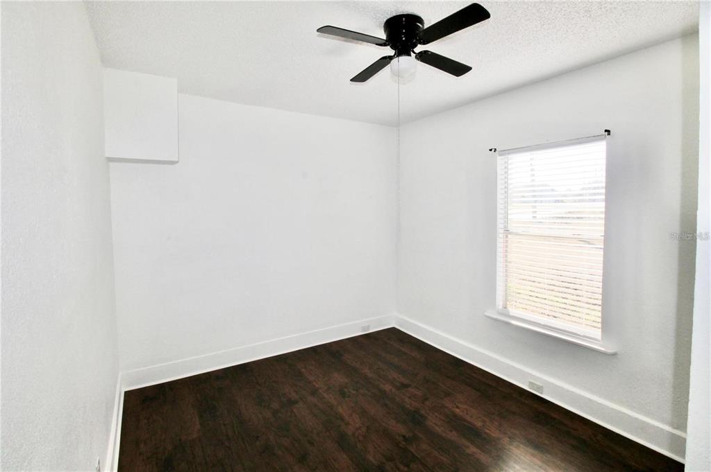 610 Dundee Road, Unit 1 Dundee, FL 33838 - Photo 17 of 28 a view of empty room with wooden floor and fan