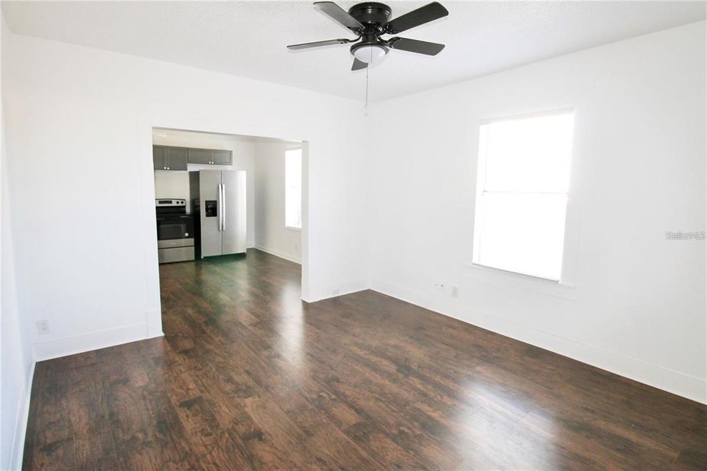 610 Dundee Road, Unit 1 Dundee, FL 33838 - Photo 6 of 28 a view of a room with wooden floor staircase and a ceiling fan