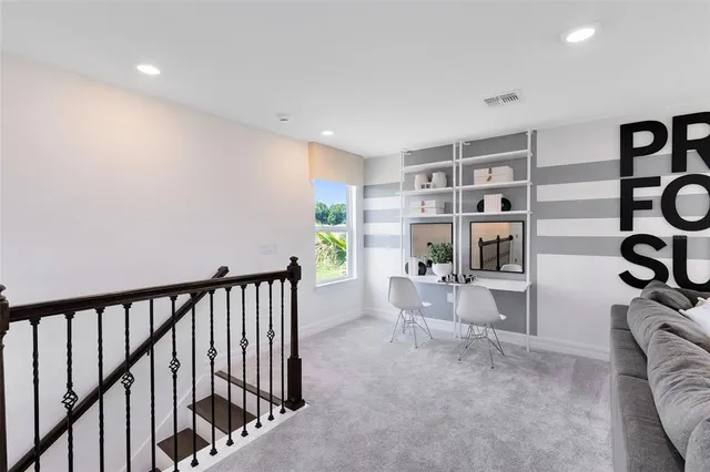 a view of a hallway with livingroom and furniture