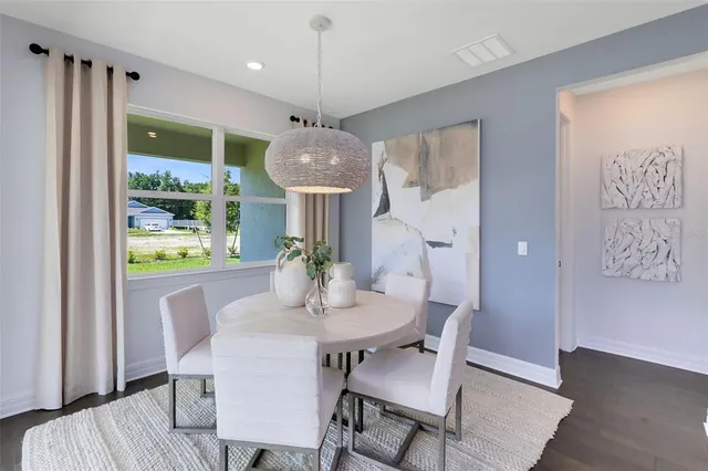 a living room with furniture flat screen tv and wooden floor