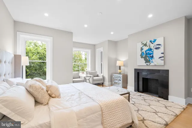 a bedroom with a bed and a fireplace