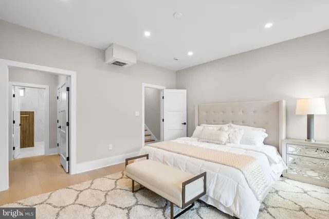 a bedroom with a bed and a lamp