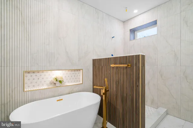 a bathroom with a bathtub and a shower