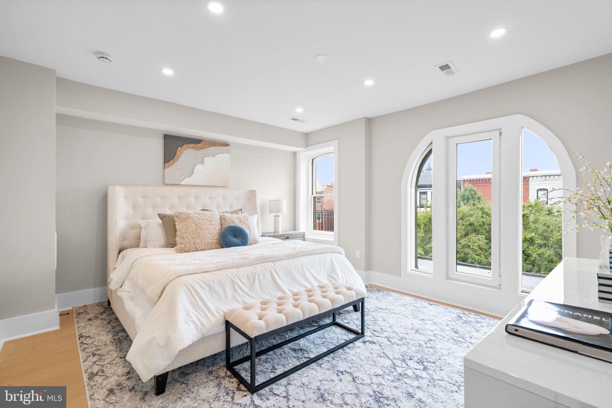 1816 13th Street Northwest Washington, DC 20009 - Photo 26 of 30 a bedroom with a large bed and a large window