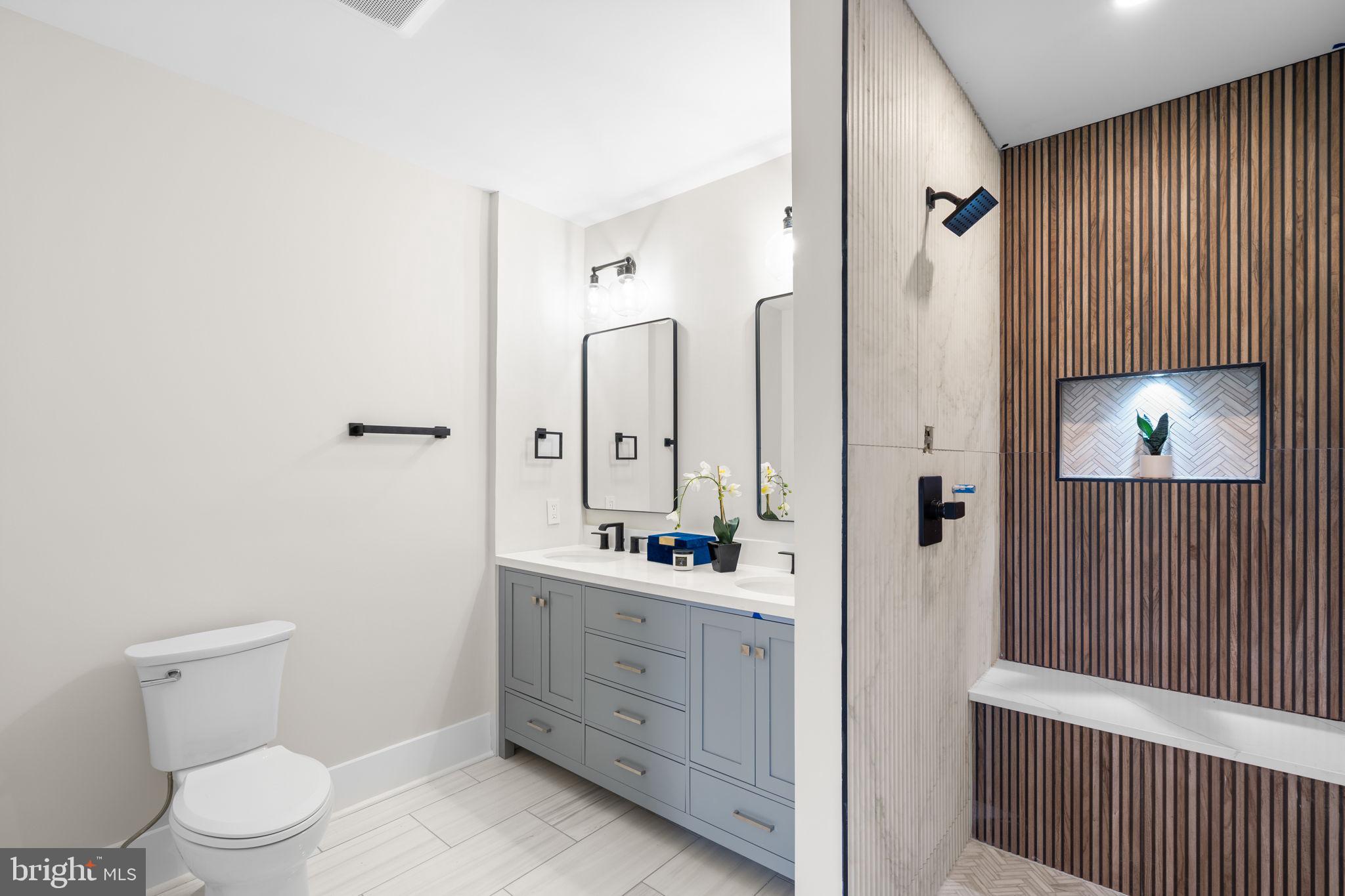 1816 13th Street Northwest Washington, DC 20009 - Photo 28 of 30 a bathroom with a sink a toilet and a mirror