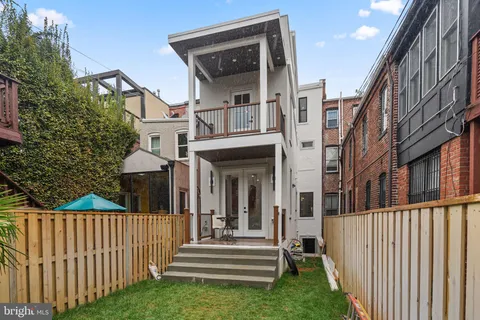 a view of a house with wooden fence
