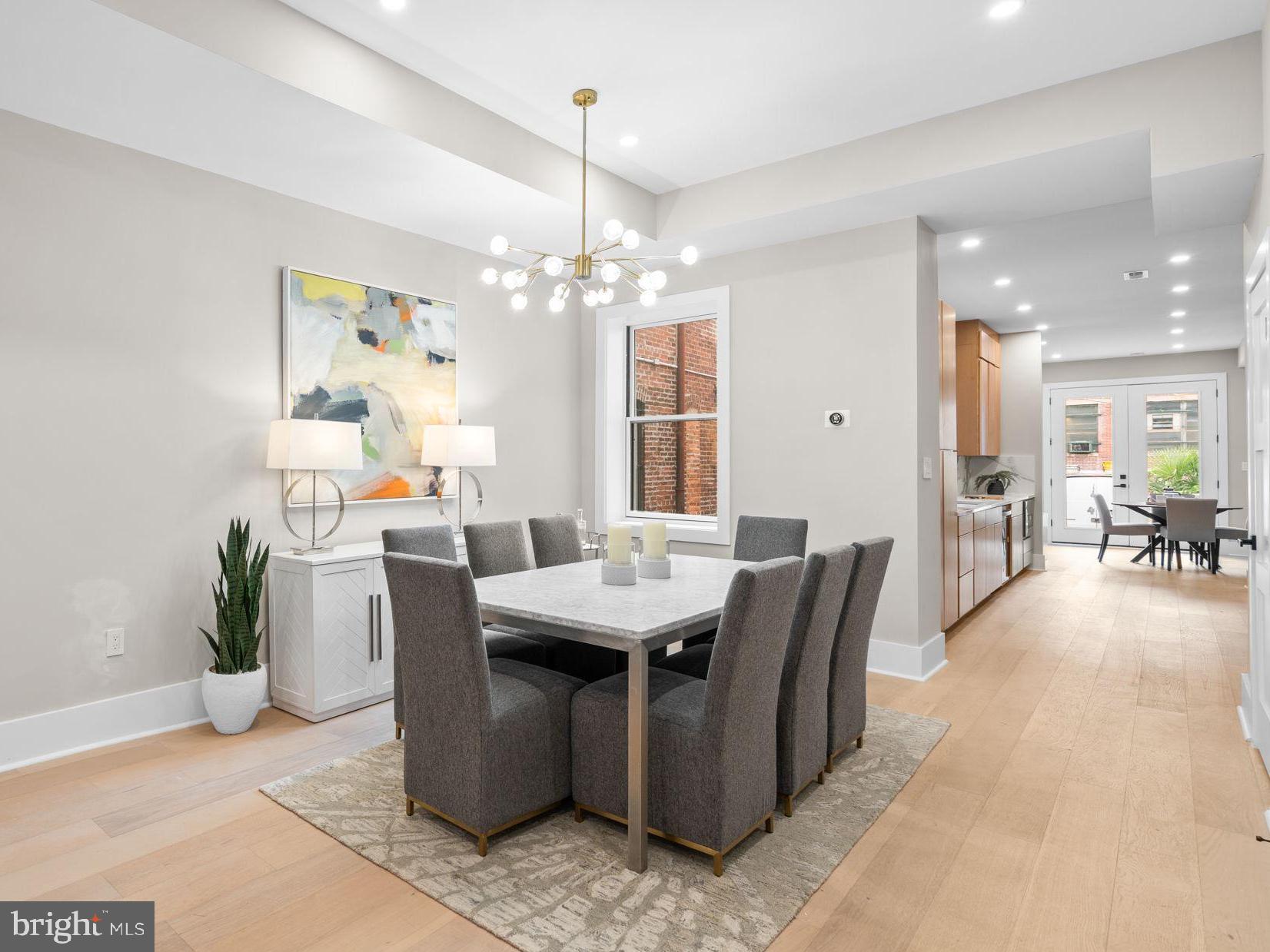 1816 13th Street Northwest Washington, DC 20009 - Photo 7 of 30 a living room with furniture a chandelier and a dining table